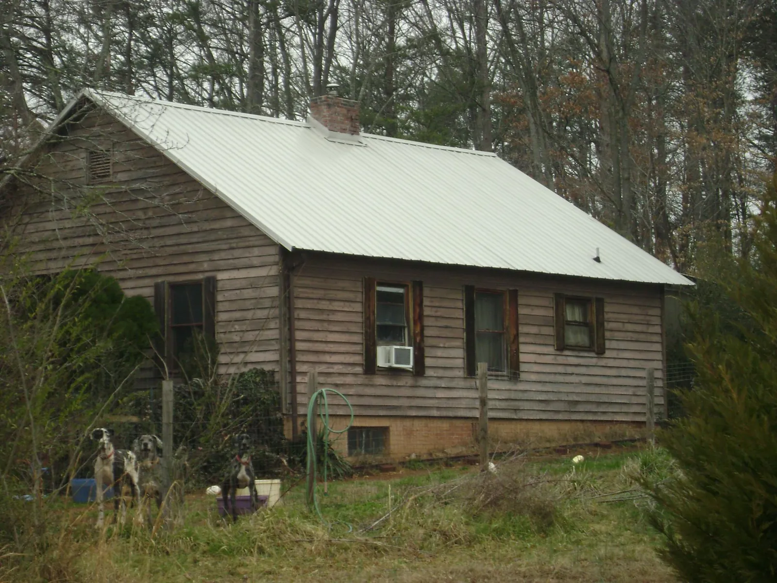 White metal roof on an old wood sided farmhouse, from a Metal Roof Installation job in Coldspring